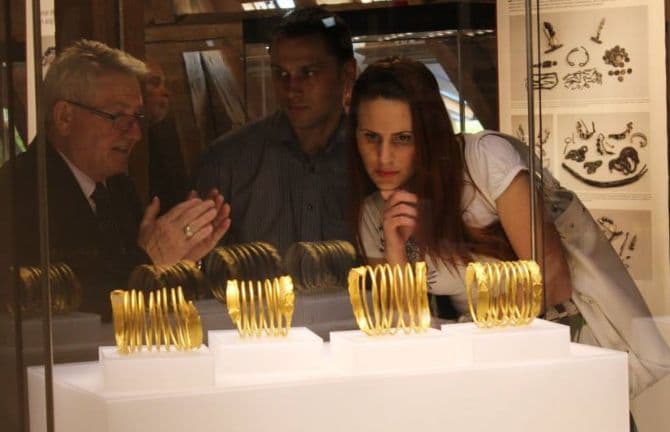 Ancient gold bracelets and coins recovered from thieves on display at Romanian museum