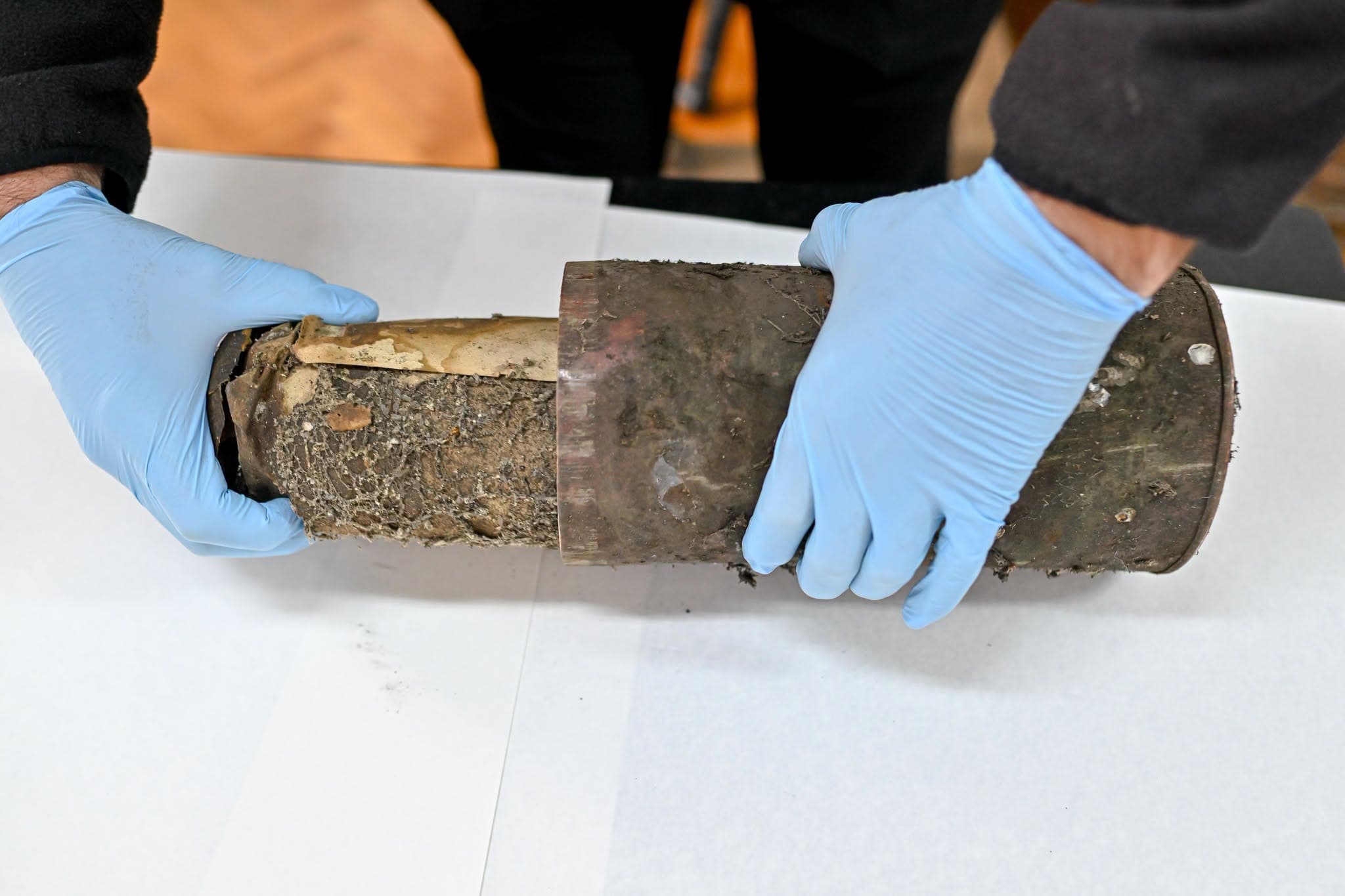 Specialist holding time capsule found in the Council Tower, Sibiu.