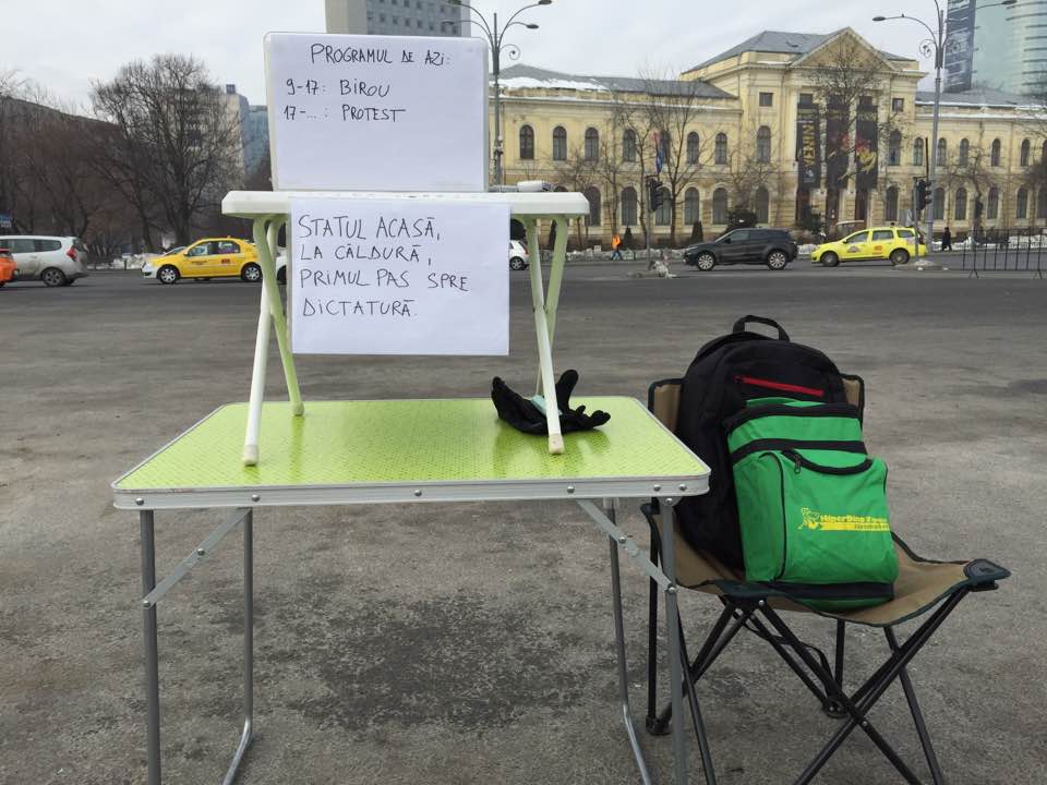 Romanian marathon runner moves office in the street so he can work and protest at the same time