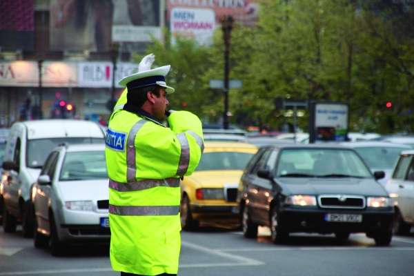 Police officer directing traffic hit by car downtown ...